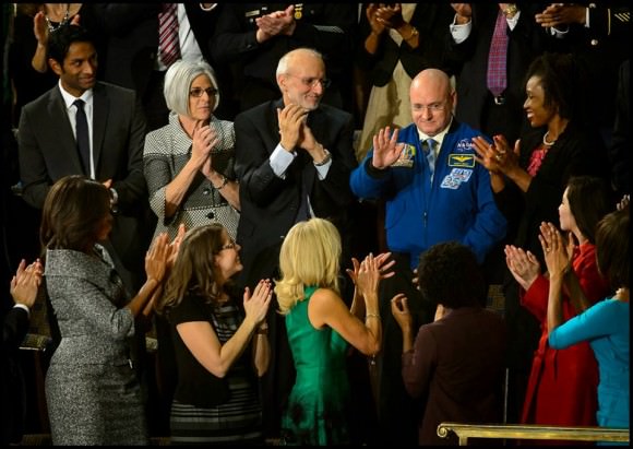 NASA astronaut Scott Kelly stands as he is recognized by President Barack Obama, while First lady Michelle Obama, front left, and other guest applaud, during the State of the Union address on Capitol Hill in Washington, Tuesday Jan. 20, 2015. This March, Astronaut Scott Kelly will launch to the International Space Station and become the first American to live and work aboard the orbiting laboratory for a year-long mission. Credit: NASA/Bill Ingalls