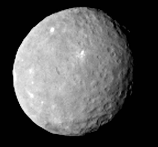 "Dawn arising." The latest image of Ceres - February 12, 2015 -  by the Dawn spacecraft from 80,000 km. With icy deposits pock marking its surface, a possible reservoir of water below its surface, is Ceres a planet, dwarf planet, an asteroid or all three? (Credit: NASA/Dawn) 