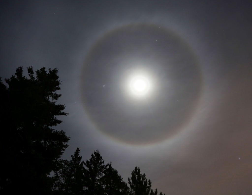 A halo rings the bright moon and planet Jupiter (left of moon) Credit: Bob King