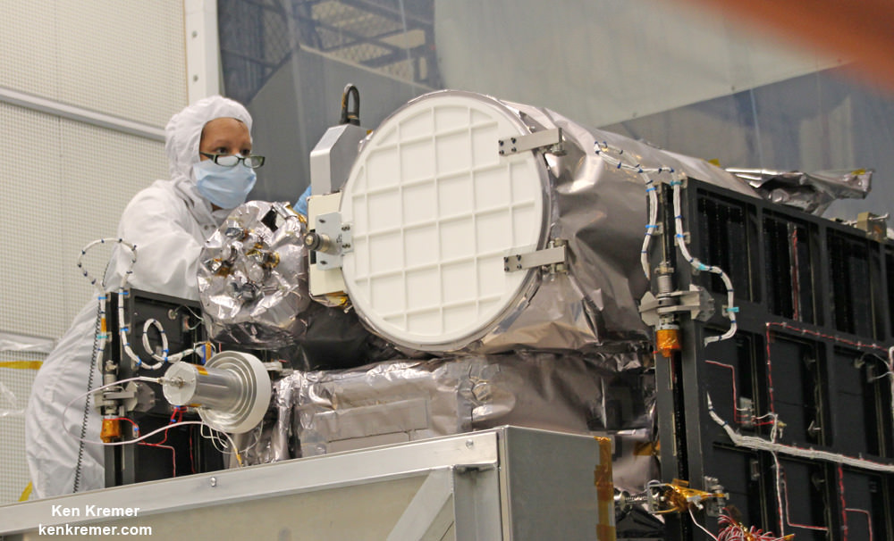 Technician works on NASA Earth science instruments and Earth imaging EPIC camera (white circle) housed on NOAA/NASA Deep Space Climate Observatory (DSCOVR) inside NASA Goddard Space Flight Center clean room in November 2014.  Credit: Ken Kremer/kenkremer.com/AmericaSpace