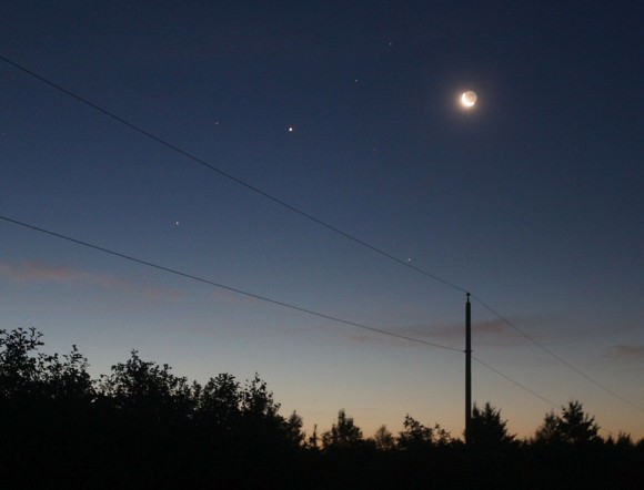 I screwed this photo up of the Moon, Jupiter and Mars by overexposing the sunlit crescent. Credit: Bob King