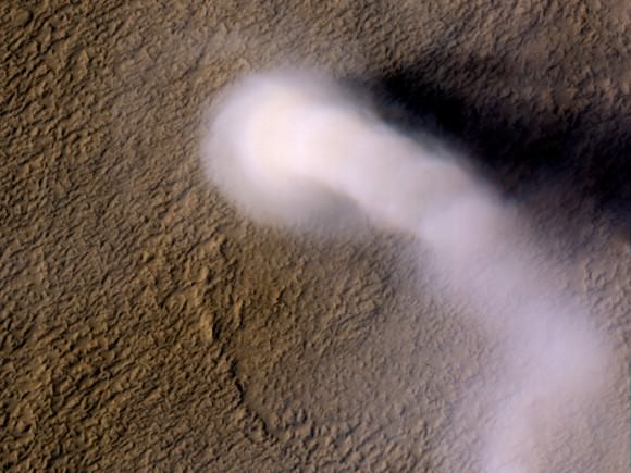 A Martian dust devil roughly 12 miles (20 kilometers) high was captured on Amazonis Planitia region of Mars, March 14, 2012 by the HiRISE camera on NASA's Mars Reconnaissance Orbiter. The plume is little more than three-quarters of a football field wide (70 yards, or 70 meters). (Image credit: NASA/JPL-Caltech/UA)