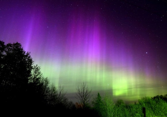 A beautiful curtain of rays spread across the northern sky just last night (May 12) as seen from Duluth, Minn. Aurora colors on Earth are caused by the excitation of nitrogen and oxygen atoms from high-speed particles from the solar wind. Oxygen is responsible for most of the aurora's greens and reds. Credit: Bob King