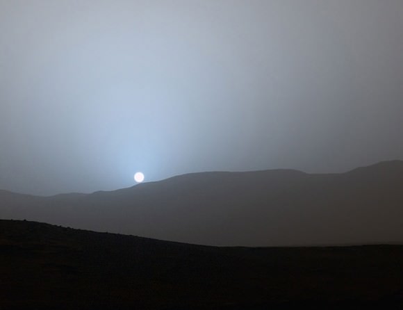 This was the first sunset observed in color by Curiosity. The color has been calibrated and white-balanced to remove camera artifacts. Mastcam sees color much the way the human eye does, although it's a little less sensitive to blue. The Sun's disk itself appears pink because all the cooler colors have been scattered away, similar to why the Sun on Earth appears orange or red when near the horizon. Notice the rocky ridge in the foreground. Credit: NASA/JPL-Caltech/MSSS/Texas A&M Univ.