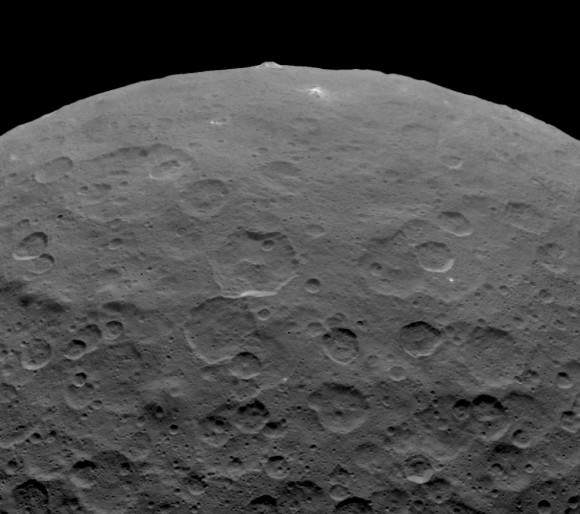 Dawn took this photo of an intriguing pyramidal mountain on Ceres on June  14 from an altitude of 2,700 miles. It rises 3 miles above a relatively smooth surface. Credit: NASA/JPL-Caltech/UCLA/MPS/DLR/IDA