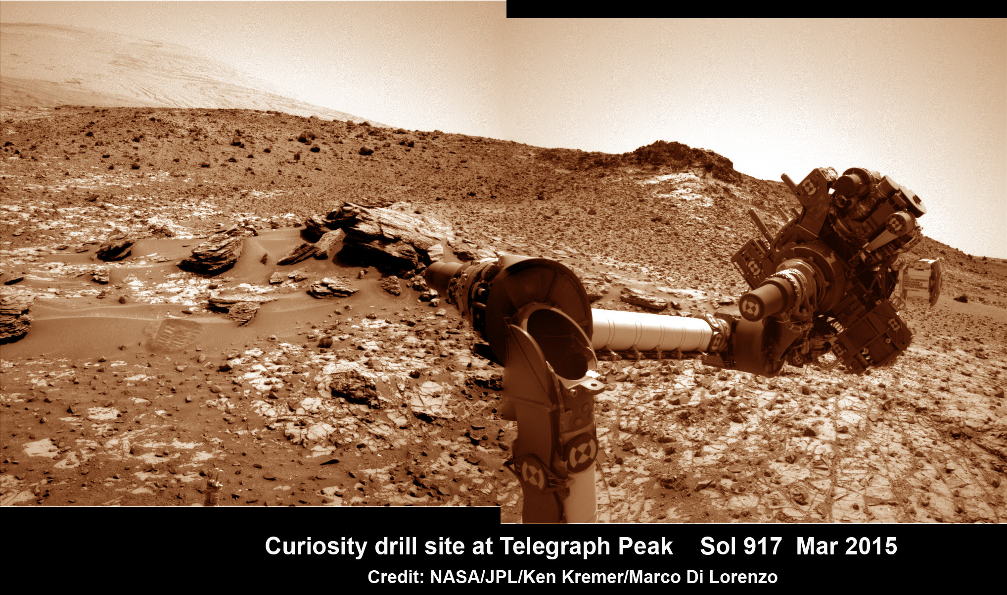 This March 6, 2015 (Sol 917), mosaic of images from the Navcam camera on NASA's Curiosity Mars rover shows the position in which the rover held its arm for several days after a transient short circuit triggered onboard fault-protection programming to halt arm activities on Feb. 27, 2015, Sol 911.  The rover team chose to hold the arm in the same position for several days of tests to diagnose the underlying cause of the Sol 911 event.  Navcam camera raw images stitched and colorized. Credit:  NASA/JPL-Caltech/Ken Kremer/kenkremer.com/Marco Di Lorenzo