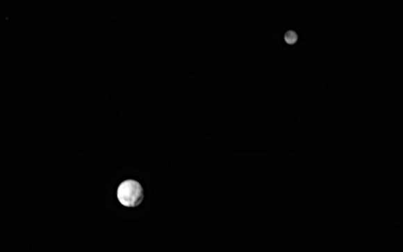 The latest photo of Pluto (lower left) and its largest moon Charon taken on June 29. A large possible crater-like feature is visible at lower right. Charon shows intriguing dark markings. Pluto's diameter is  1,471 miles (700 miles smaller than Earth's Moon); Charon is 750 miles across. Credit: NASA/Johns Hopkins University Applied Physics Laboratory/Southwest Research Institute