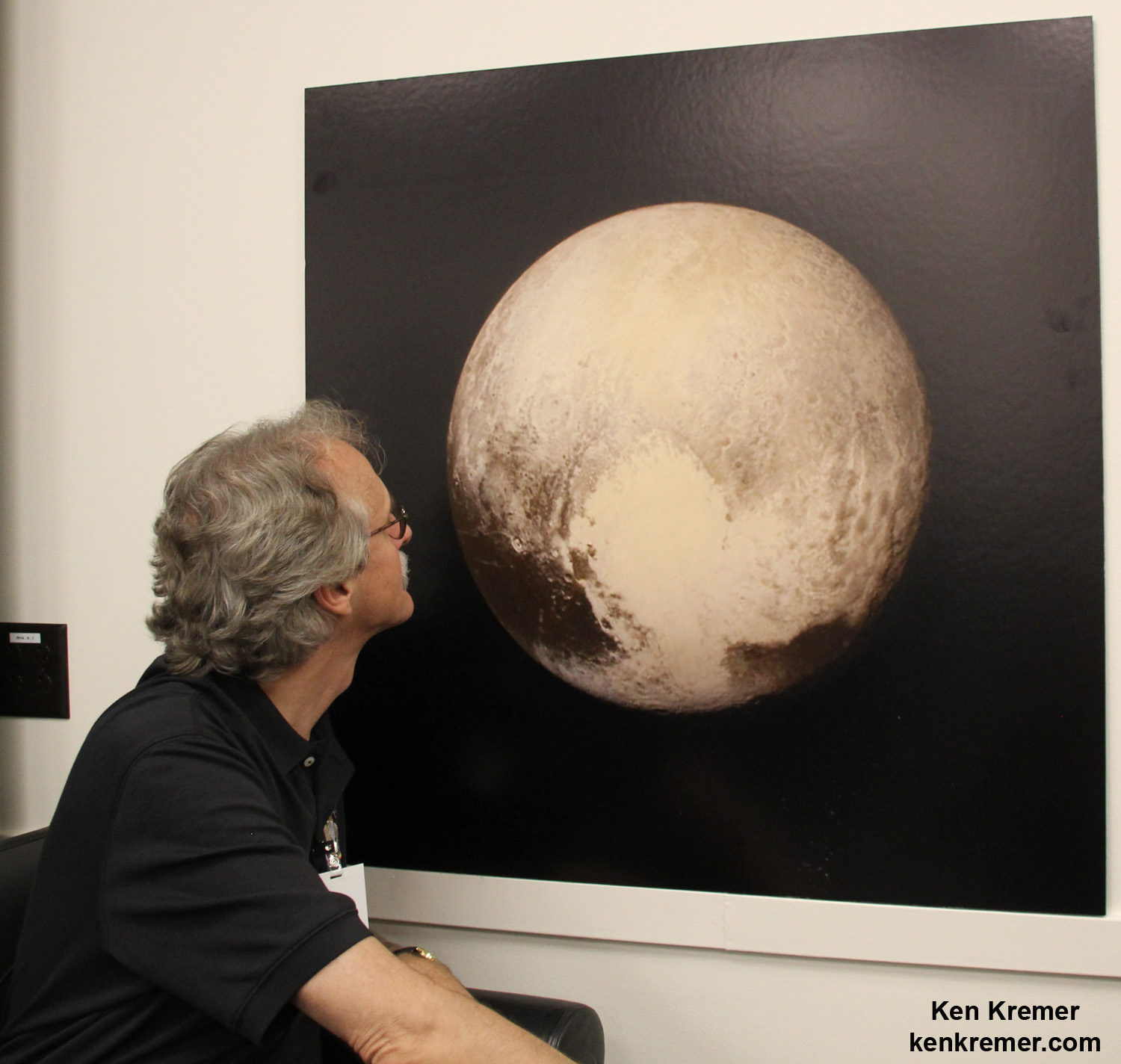 New Horizons science team co-investigator John Spencer examines print of the newest Pluto image taken on July 13, 2015 after the successful Pluto flyby. Credit: Ken Kremer/kenkremer.com 