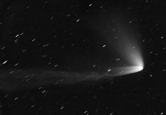 Comet C/2014 Q1 PanSTARRS displays three remarkable tails in this photo taken on July 15, 2015. The ion or gas tail stretches to the left. The primary dust tail is bright and overlaps the gas tail. A third broad and diffuse tail juts off to the upper left of the coma. Credit: Michael Jaeger