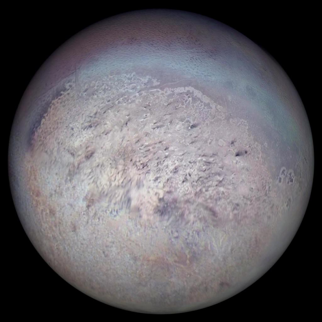 Neptune's largest moon Triton photographed on August 25, 1989 by Voyager 2. It's a captured Kuiper Belt Object, and its capture started a chain of events that led to Hippocamp, the little moon that shouldn't be there. Credit: NASA