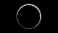 Backlit by the sun, Pluto’s atmosphere rings its silhouette like a luminous halo in this image taken by NASA’s New Horizons spacecraft around midnight EDT on July 15. This global portrait of the atmosphere was captured when the spacecraft was about 1.25 million miles (2 million kilometers) from Pluto and shows structures as small as 12 miles across. The image, delivered to Earth on July 23, is displayed with north at the top of the frame.  Credits: NASA/JHUAPL/SwRI