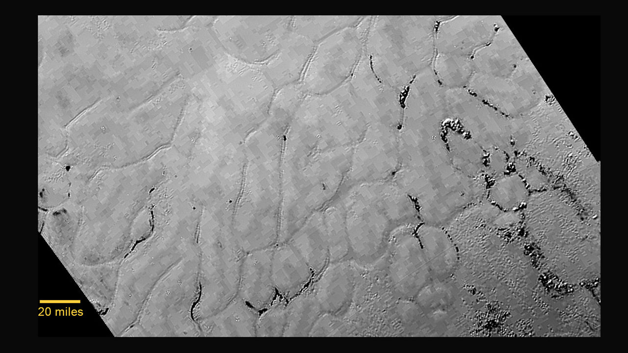In the center left of Pluto’s vast heart-shaped feature – informally named “Tombaugh Regio” - lies a vast, craterless plain that appears to be no more than 100 million years old, and is possibly still being shaped by geologic processes. This frozen region is north of Pluto’s icy mountains and has been informally named Sputnik Planum (Sputnik Plain), after Earth’s first artificial satellite. The surface appears to be divided into irregularly-shaped segments that are ringed by narrow troughs. Features that appear to be groups of mounds and fields of small pits are also visible. This image was acquired by the Long Range Reconnaissance Imager (LORRI) on July 14 from a distance of 48,000 miles (77,000 kilometers). Features as small as one-half mile (1 kilometer) across are visible. The blocky appearance of some features is due to compression of the image. Credits: NASA/JHUAPL/SWRI 