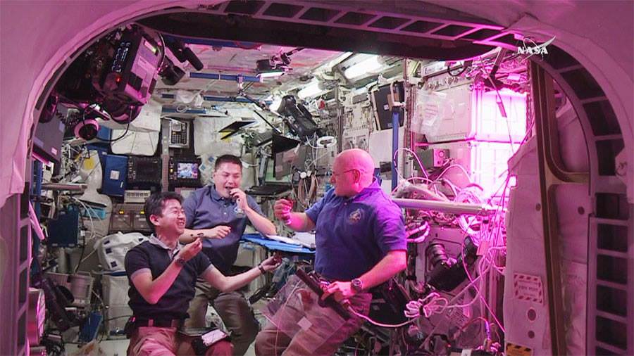 NASA Astronauts Kjell Lindgren (center) and Scott Kelly (right) and Kimiya Yui (left) of Japan consume space grown food for the first time ever, from the aboard the  from the Veggie plant growth system on the International Space Station.  Credit: NASA TV