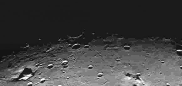 Craters and fissures on Charon photographed during the flyby. Credit: NASA