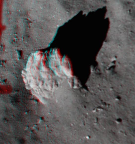 This 3D image focuses on the largest boulder seen in the image captured 221 feet (67.4 m) above Comet 67P/Churyumov–Gerasimenko looks best in a pair of red-blue 3D glasses. Many fractures, along with a tapered ‘tail’ of debris and excavated ‘moat’ around the 5 m-high boulder, are plain to see. Credit: ESA/Rosetta/Philae/ROLIS/DLR