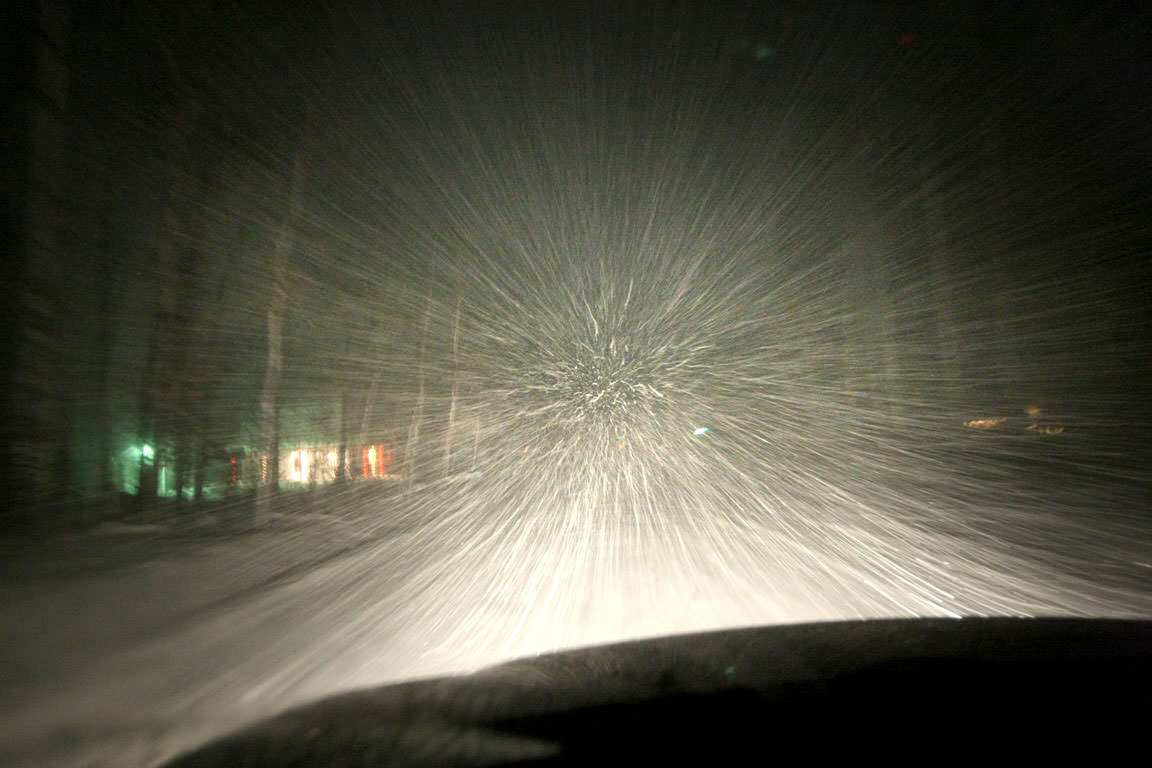 At some personal peril, I grabbed a photo of snow in the headlights while driving home in a recent storm. Meteors in a meteor shower appear to radiate from a point in the distance in identical fashion. Photo: Bob King