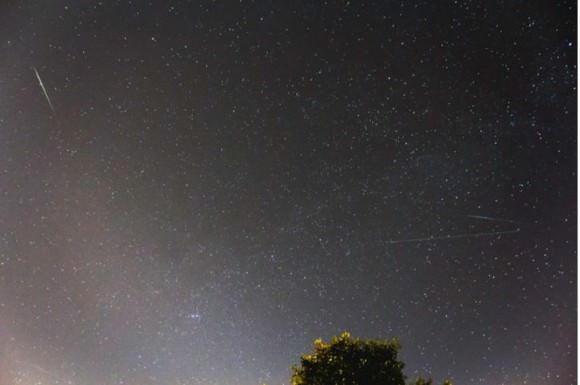 A green Perseid meteor, along with 2 satellites show up in this image taken on August 11, 2015. Credit and copyright: eos-001 on Flickr. 