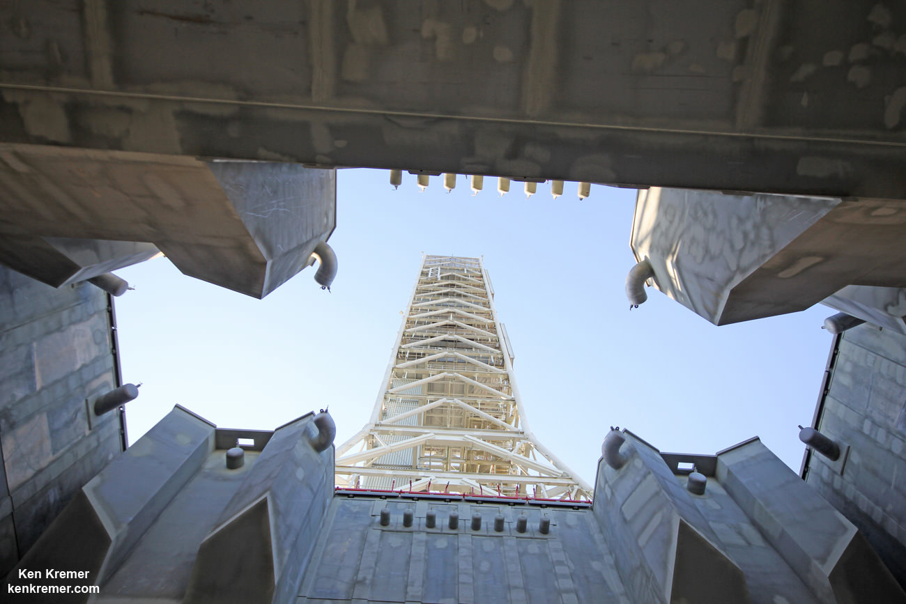 Looking up from beneath the enlarged exhaust hole of the Mobile Launcher to the 380 foot-tall tower astronauts will ascend as their gateway for missions to the Moon, Asteroids and Mars.   The ML will support NASA's Space Launch System (SLS) and Orion spacecraft during Exploration Mission-1 at NASA's Kennedy Space Center in Florida.  Credit: Ken Kremer/kenkremer.com