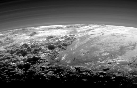 Closer Look: Majestic Mountains and Frozen Plains: Just 15 minutes after its closest approach to Pluto on July 14, 2015, NASA’s New Horizons spacecraft looked back toward the sun and captured this near-sunset view of the rugged, icy mountains and flat ice plains extending to Pluto’s horizon. The smooth expanse of the informally named Sputnik Planum (right) is flanked to the west (left) by rugged mountains up to 11,000 feet (3,500 meters) high, including the informally named Norgay Montes in the foreground and Hillary Montes on the skyline. The backlighting highlights more than a dozen layers of haze in Pluto’s tenuous but distended atmosphere. The image was taken from a distance of 11,000 miles (18,000 kilometers) to Pluto; the scene is 230 miles (380 kilometers) across. Credits: NASA/JHUAPL/SwRI)