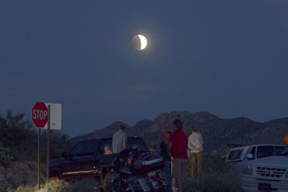 A crowd gather to watch the Moon during partial eclipse prior to totality. Credit: Robert Sparks