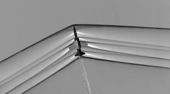 This schlieren image dramatically displays the shock wave of a supersonic jet flying over the Mojave Desert. Researchers used NASA-developed image processing software to remove the desert background, then combined and averaged multiple frames to produce a clear picture of the shock waves. Credit: NASA.