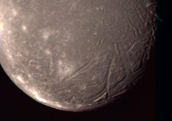 The highest-resolution Voyager 2 color image of Ariel. Canyons with floors covered by smooth plains are visible at lower right. The bright crater Laica is at lower left. Credit: NASA/JPL