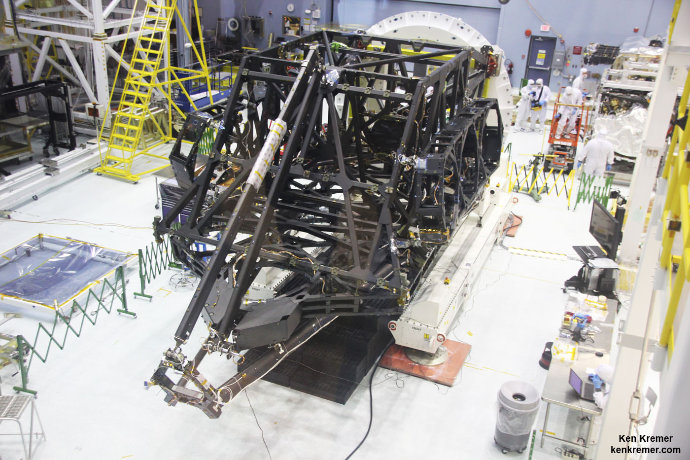 View showing actual flight structure of mirror backplane unit for NASA's James Webb Space Telescope (JWST) that holds 18 segment primary mirror array and secondary mirror mount at front, in stowed-for-launch configuration.  JWST is being assembled here by technicians inside the world’s largest cleanroom at NASA Goddard Space Flight Center, Greenbelt, Md.  Credit: Ken Kremer/kenkremer.com