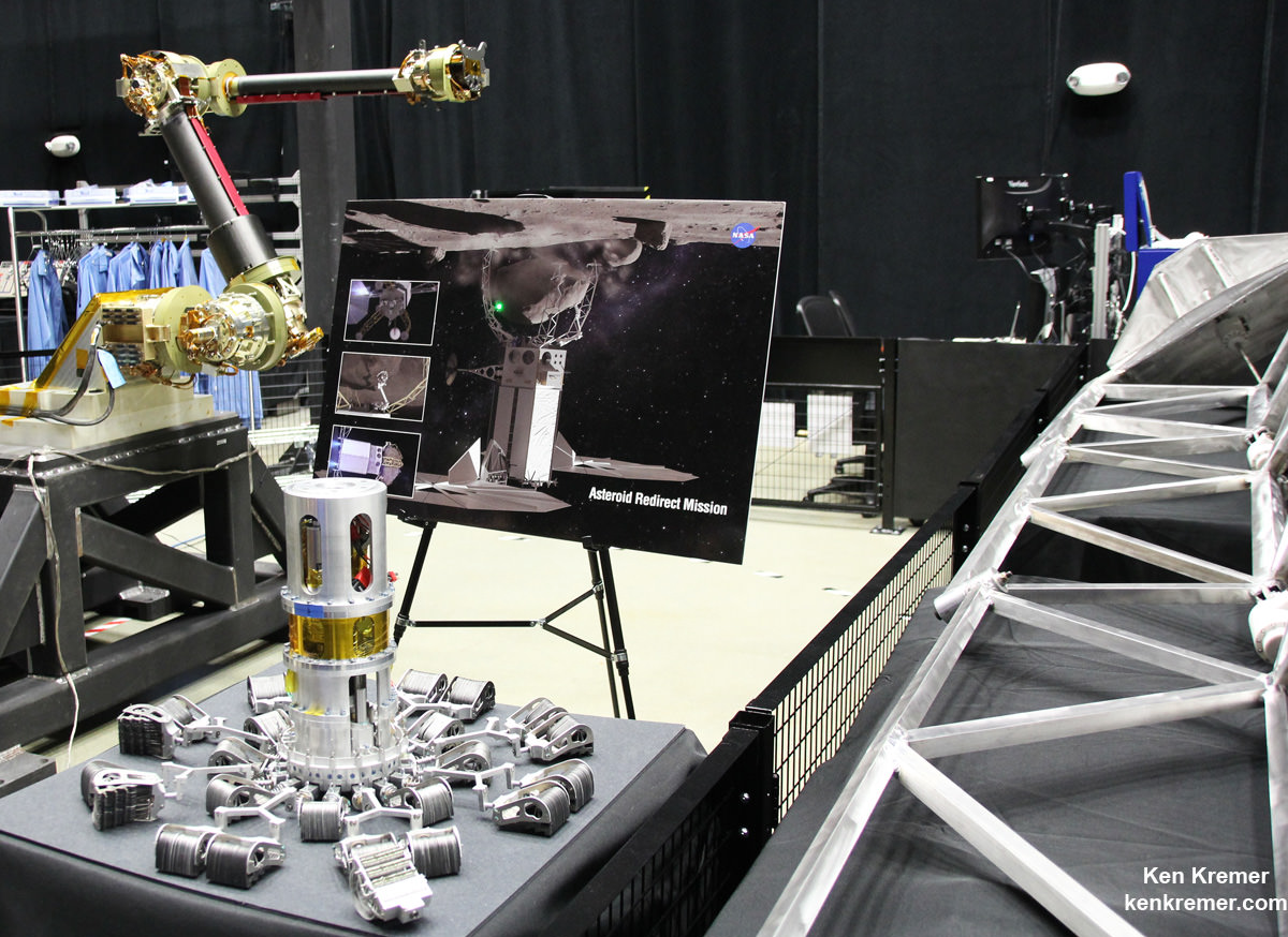 View of the robotic arm above and gripper tool below that initially grabs the asteroid boulder before the capture legs wrap around as planned for NASA’s upcoming unmanned ARRM Asteroid Redirect Robotic Mission that will later dock with an Orion crew vehicle. Credit: Ken Kremer/kenkremer.com