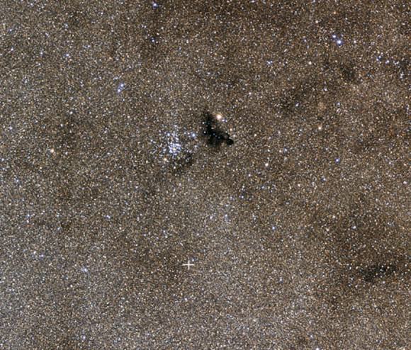 The pretty star cluster NGC 6520 and Ink Spot Nebula Barnard 86. The cross shows the location of the nova. Credit: Johannes Schedler / panther-observatory.com