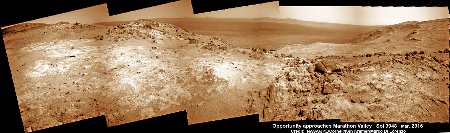 NASA’s Opportunity Rover scans along a spectacular overlook toward Marathon Valley on March 3, 2015, showing flat-faced rocks exhibiting a completely new composition from others examined earlier. Marathon Valley and Martian cliffs on Endeavour crater hold deposits of water altered clay minerals. This navcam camera photo mosaic was assembled from images taken on Sol 3948 (March 3, 2015) and colorized. Credit: NASA/JPL/Cornell/Ken Kremer/kenkremer.com/Marco Di Lorenzo