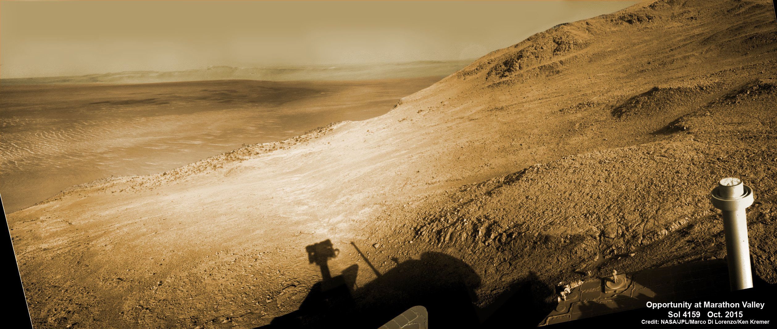 Mosaic view from Opportunity rover looking along the high walls and down the floor of Marathon Valley with deposits of water altered clay minerals and out to the vast expense of Endeavour Crater. This navcam camera photo mosaic was assembled from images taken on Sol 4159  (Oct. 5, 2015) and colorized.  Credit: NASA/JPL/Cornell/Marco Di Lorenzo/Ken Kremer/kenkremer.com 