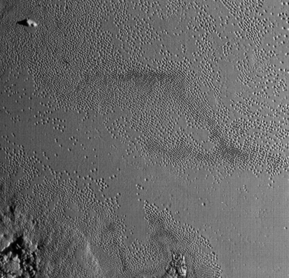 Life's definitely the pits on Pluto's Tombaugh Regio. This photo shows the fainter "ghost" pits well. Is ice filling them in or are we seeing the start of a pit's formation? Credit: 
