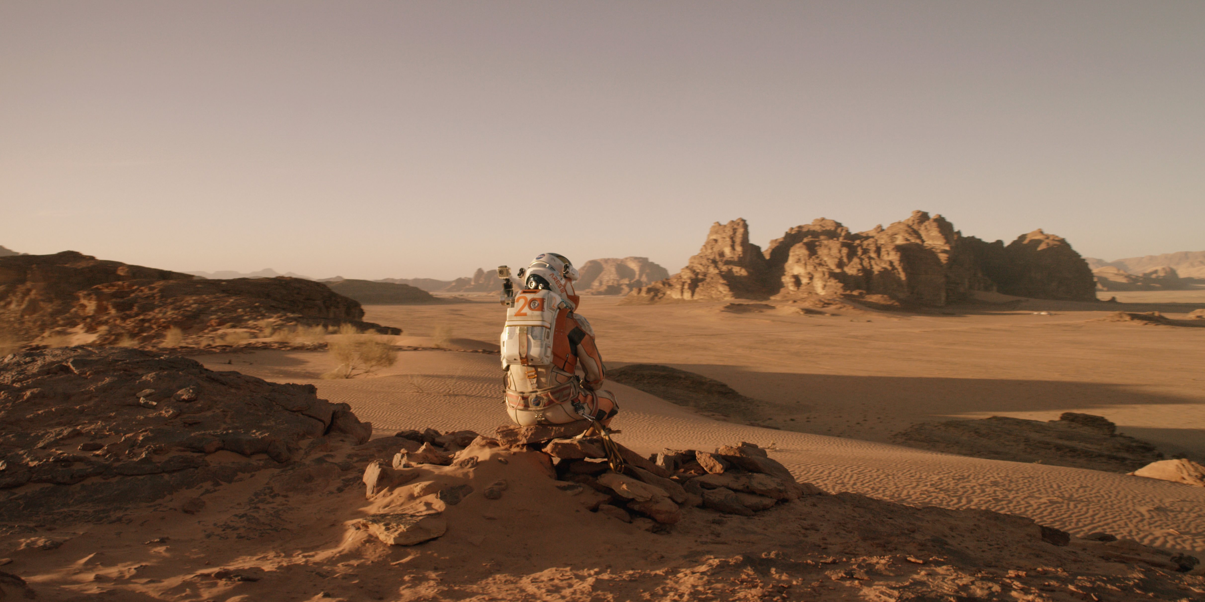 Scene from ‘The Martian’ starring Matt Damon as NASA astronaut Mark Watney contemplating magnificent panoramic vista while stranded alone on Mars.    Credits: 20th Century Fox