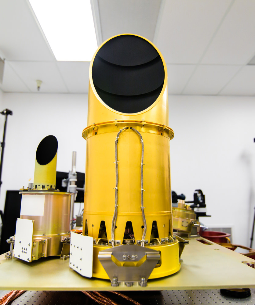 The University of Arizona’s camera suite, OCAMS, sits on a test bench that mimics its arrangement on the OSIRIS-REx spacecraft. The three cameras that compose the instrument – MapCam (left), PolyCam and SamCam – are the eyes of NASA’s OSIRIS-REx mission. They will map the asteroid Bennu, help choose a sample site, and ensure that the sample is correctly stowed on the spacecraft.  Credits: University of Arizona/Symeon Platts