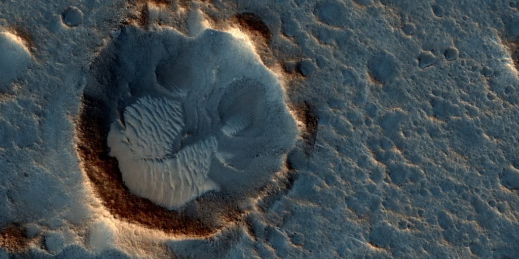Mars may be a dry, frigid, lifeless planet. But it's still oddly captivating and haunting, probably because we know that Earth will one day resemble it. This May 2015 image from the HiRISE camera on NASA's Mars Reconnaissance Orbiter shows a location on Mars associated with the best-selling novel and Hollywood movie, "The Martian." It is in a region called Acidalia Planitia. Credits: NASA/JPL-Caltech/Univ. of Arizona