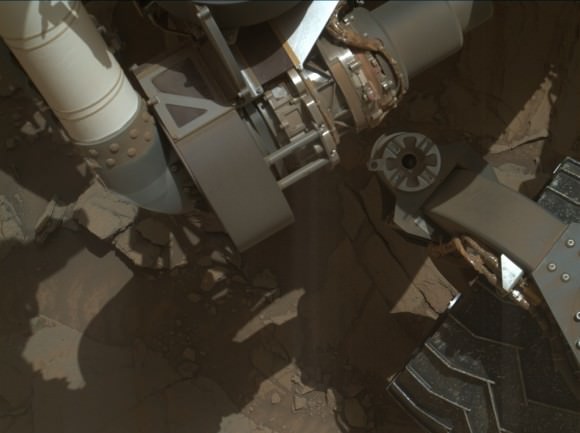 A small portion of the Curiosity rover's robotic arm (the white 'tube' on the top left of the image) shows up in one of the original raw images used to create the montage 'selfie.' Credit: NASA/JPL-Caltech/MSSS.