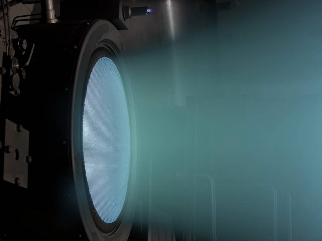 NASA Evolutionary Xenon Thruster being tested in a vacuum chamber. Image Credit: NASA