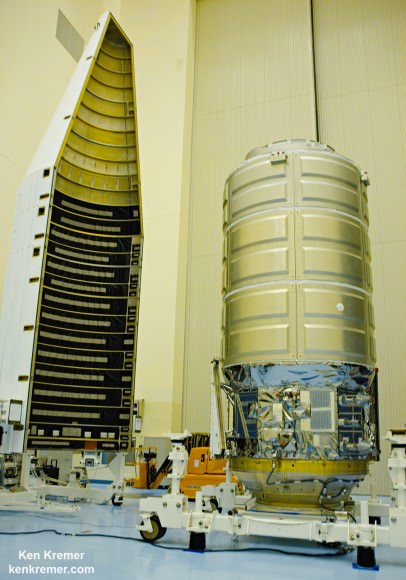 This close up view shows a payload fairing and the Orbital ATK Cygnus spacecraft it will encapsulate during media visit inside the Kennedy Space Center clean room facility on Nov. 13, 2015.  Launch on  ULA Atlas V is slated for Dec. 3, 2015.  Credit: Ken Kremer/kenkremer.com