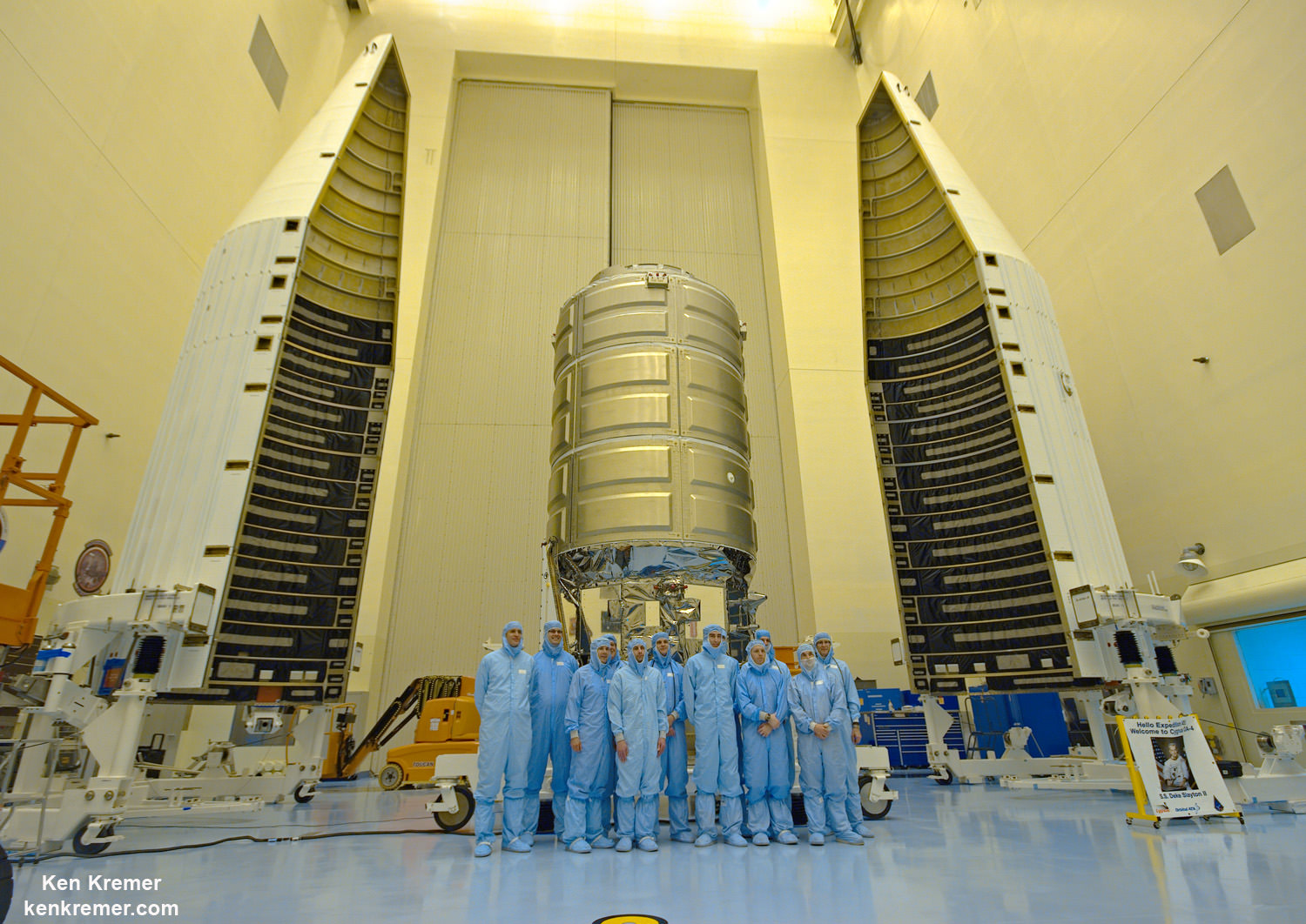 The processing team preparing the  Orbital ATK Cygnus spacecraft for launch on Dec. 3, 2015 poses with the SS Deke Slayton II cargo ship and twin payload enclosure fairings inside the Kennedy Space Center clean room during media visit on Nov. 13, 2015.  Credit: Ken Kremer/kenkremer.com