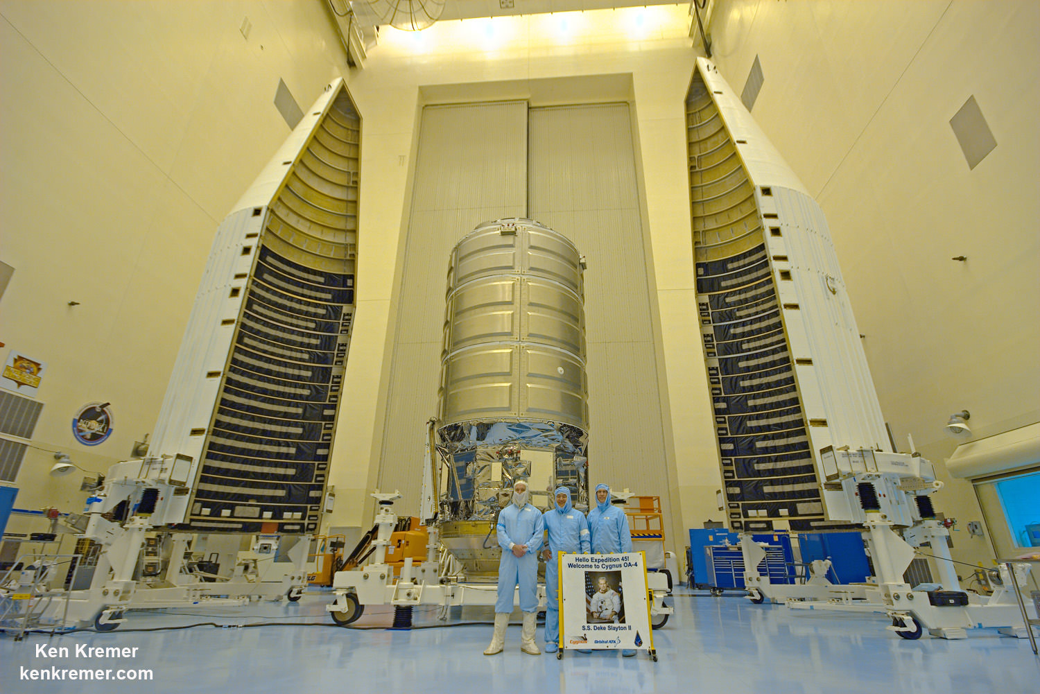 Inside the Payload Hazardous Servicing Facility high bay clean room at NASA's Kennedy Space Center in Florida, where the Orbital ATK Cygnus pressurized module is being processed for Dec. 3, 2015 launch, Dan Tani, former astronaut and now Orbital ATK VP for Mission and Cargo Operations, center, poses with Cygnus and mural of Deke Slayton, along with Randy Gordon, Launch Support Project manager for NASA, and Kevin Leslie, ULA Mission manager. Credit: Ken Kremer/kenkremer.com