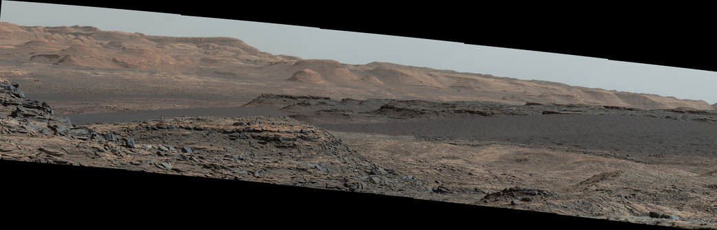 This Sept. 25, 2015, view from the Mast Camera on NASA's Curiosity Mars rover shows a dark sand dune in the middle distance.  The rover's examination of dunes on the way toward higher layers of Mount Sharp will be the first in-place study of an active sand dune anywhere other than Earth.  Credits: NASA/JPL-Caltech/MSSS