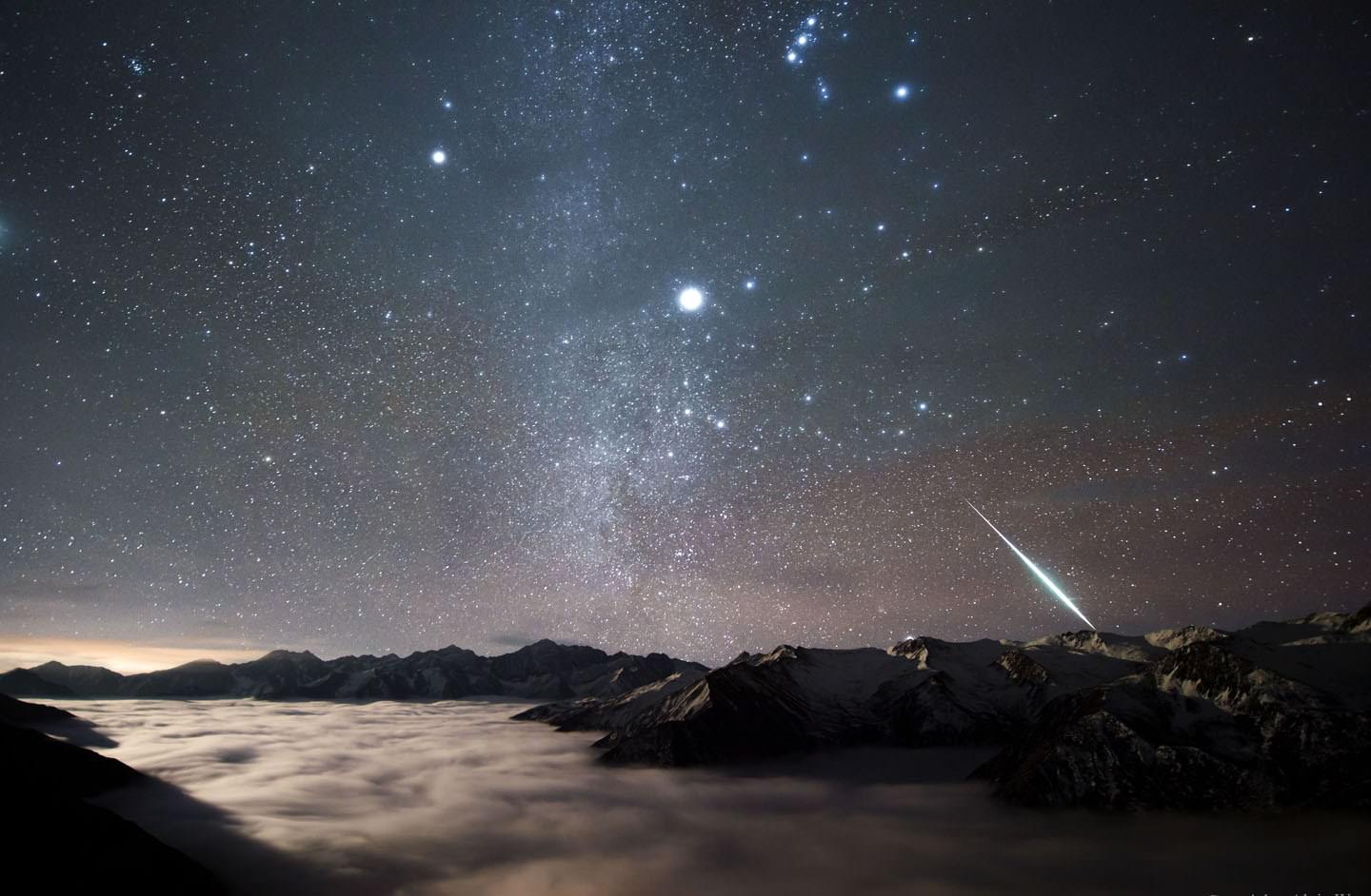 A brilliant Geminid flashes below Sirius and Orion over Mount Balang in China. Credit: NASA/Alvin Wu