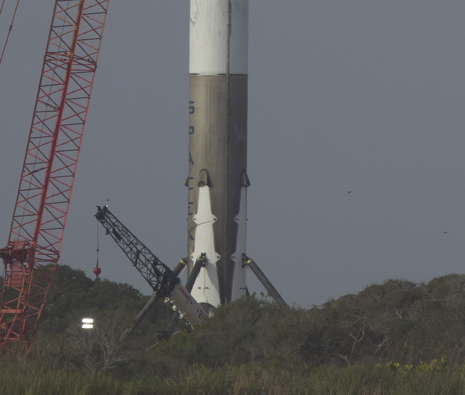 Up close post landing ocean view of landing legs at base of SpaceX Falcon 9 at Landing Zone 1 the day after stage touchdown at Landing Zone 1 on Dec 21, 2015 at Cape Canaveral, Fla.  Credit: Jeff Seibert/AmericaSpace
