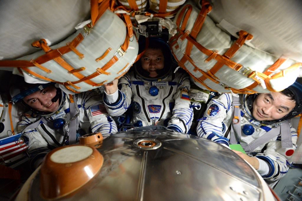 Expedition 45 crew members Kjell Lindgren of NASA, Oleg Kononenko of the Russian Federal Space Agency and Kimiya Yui of the Japan Aerospace Exploration Agency settle into the Soyuz TMA-17M spacecraft that carried them safely back to Earth on Dec. 11, 2015 after their 141-day mission aboard the International Space Station.  Credits: NASA 