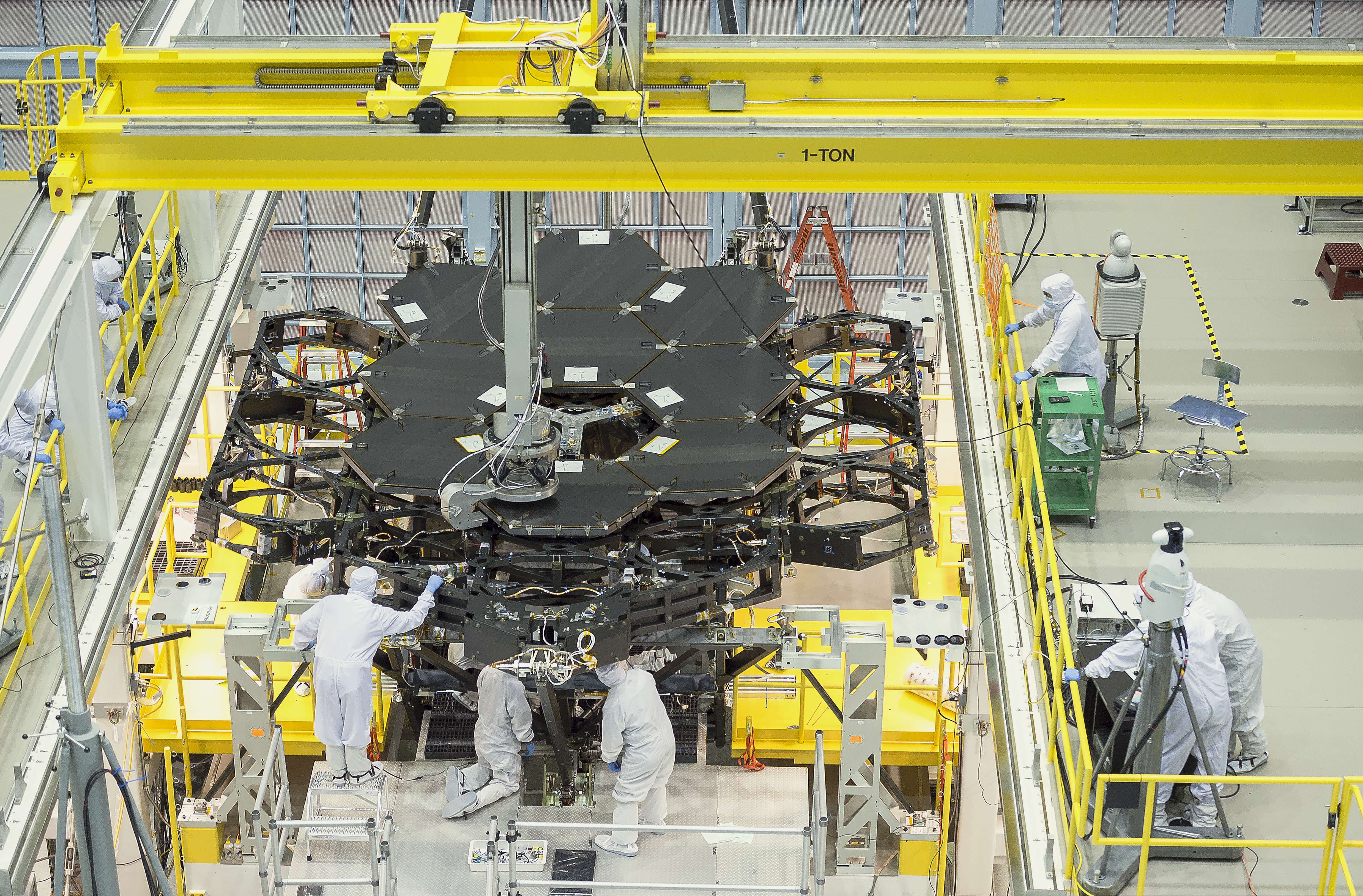 Engineers worked tirelessly to install the ninth primary flight mirror onto the telescope structure.  Credits: NASA's Goddard Space Flight Center/Chris Gunn