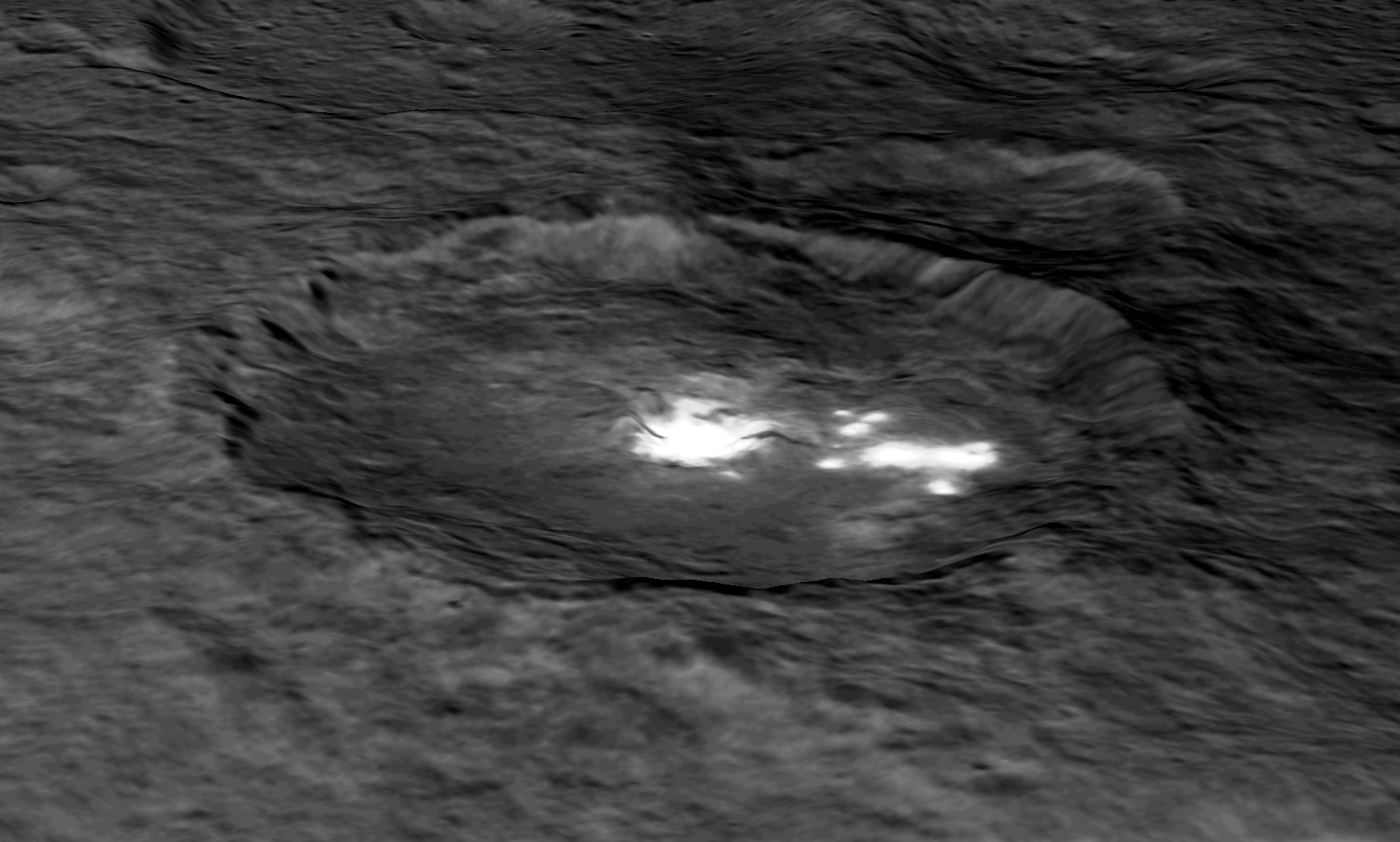 An image of Occator Crater draped over a digital terrain model provides a 3-D-like perspective view of the impact structure.  Several bright areas can be seen in this crater. The inner part of the crater forms a type of “crater within a crater” measuring about 6 miles (10 kilometers) in diameter and 0.3 miles (0.5 miles) in depth, and contains the brightest material on all of Ceres. Occator measures about 60 miles (90 kilometers) wide.  Credits: NASA/JPL-Caltech/UCLA/MPS/DLR/IDA