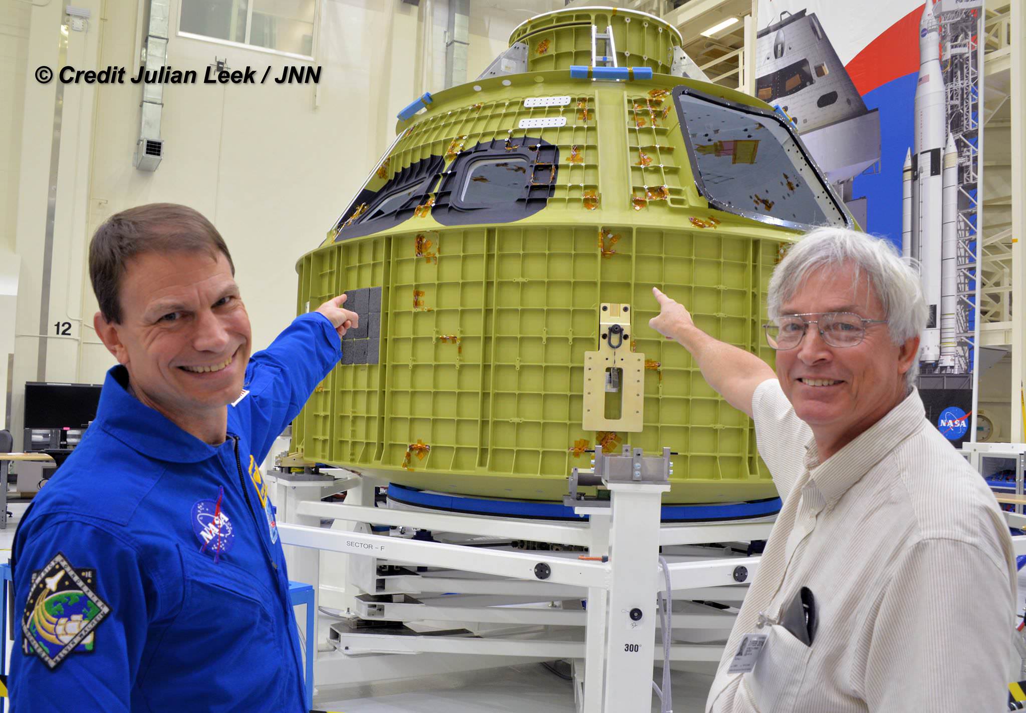 NASA astronaut Stan Love and Universe Today’s Ken Kremer point the way to the Orion EM-1 pressure vessel and its future flight to the Moon in 2018. The newly arrived Orion is being outfitted with all of its flight systems inside the Neil Armstrong Operations and Checkout Building high bay at NASA's Kennedy Space Center in Florida.  Credit: Julian Leek