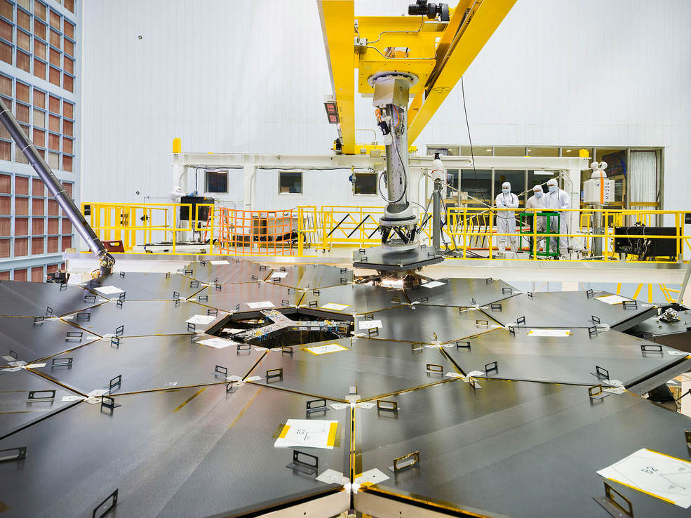 Inside a massive clean room at NASA's Goddard Space Flight Center in Greenbelt, Maryland the James Webb Space Telescope team used a robotic am to install the last of the telescope's 18 mirrors onto the telescope structure.  Credits: NASA/Chris Gunn