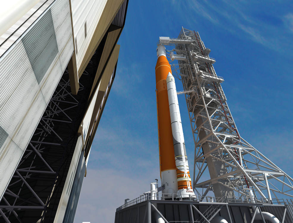 This artist concept depicts the Space Launch System rocket rolling out of the Vehicle Assembly Building at NASA's Kennedy Space Center. SLS will be the most powerful rocket ever built and will launch the agency’s Orion spacecraft into a new era of exploration to destinations beyond low-Earth orbit.  Credits: NASA/Marshall Space Flight Center