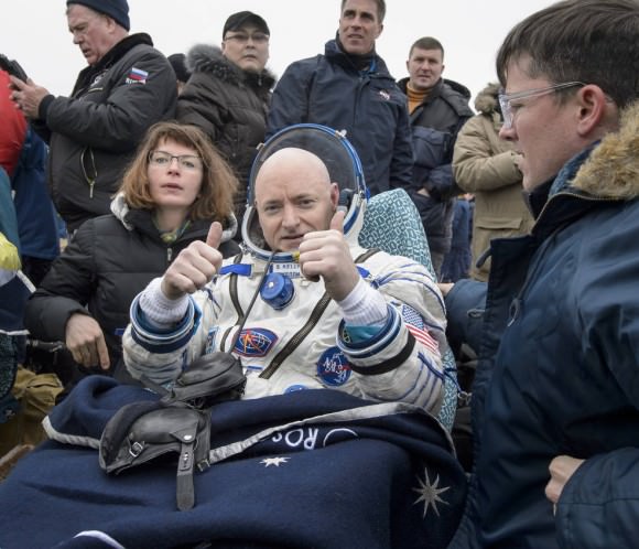 Expedition 46 Commander Scott Kelly of NASA rests in a chair outside of the Soyuz TMA-18M spacecraft just minutes after he and cosmonauts Mikhail Kornienko and Sergey Volkov of the Russian space agency Roscosmos landed in a remote area near the town of Zhezkazgan, Kazakhstan late Tuesday, March 1 EST. Credits: NASA/Bill Ingalls